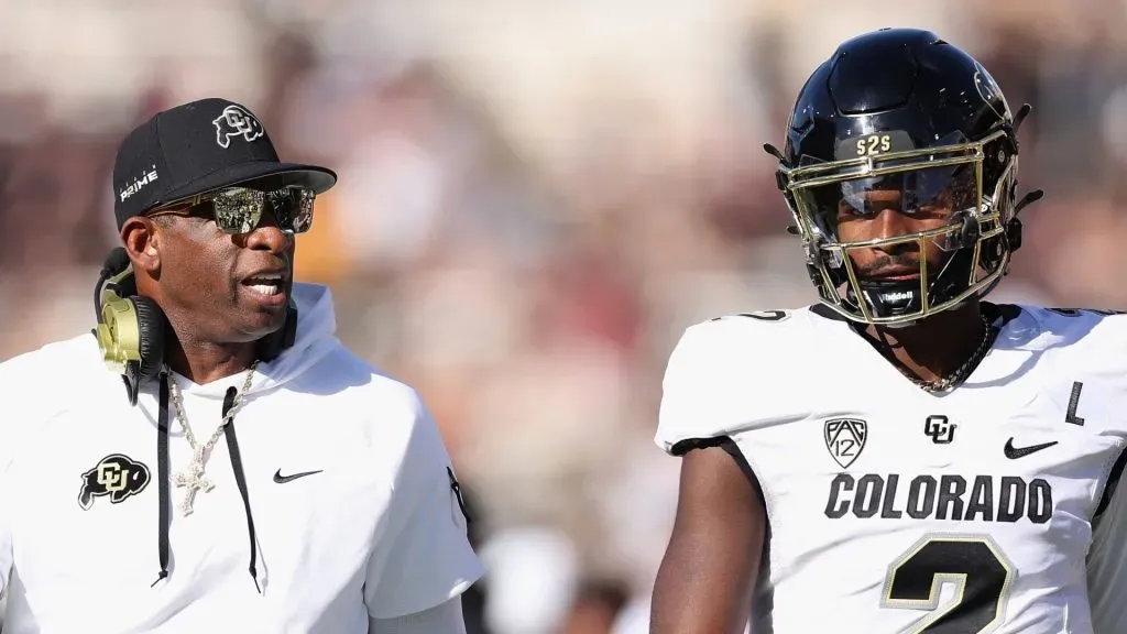 Head coach Deion Sanders of the Colorado Buffaloes talks with quarterback Shedeur Sanders #2 during first half of the NCAAF game against the Arizona State Sun Devils at Mountain America Stadium on October 07, 2023 in Tempe, Arizona.