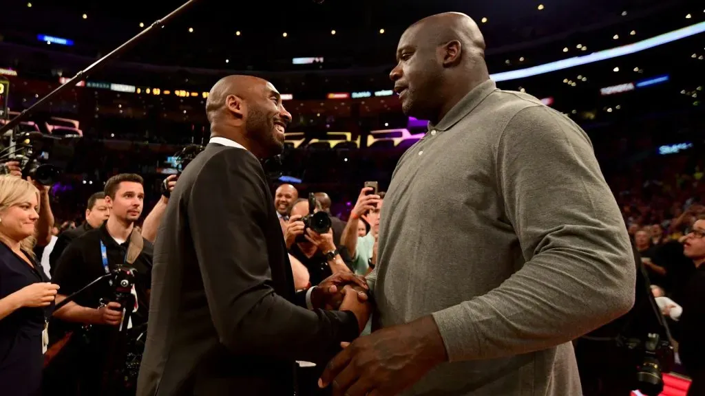 Kobe Bryant and Shaquille O’Neal shake hands at halftime after both of Bryant’s #8 and #24 Los Angeles Lakers jerseys are retired at Staples Center. (Photo by Harry How/Getty Images)