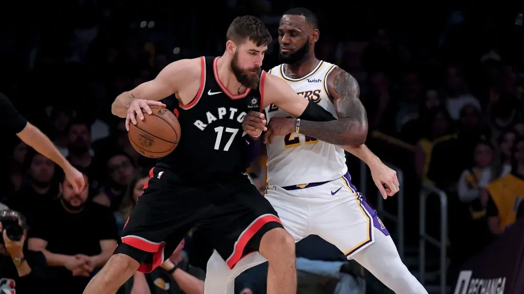 LeBron James #23 of the Los Angeles Lakers plays defense on Jonas Valanciunas #17 of the Toronto Raptors. Harry How/Getty Images