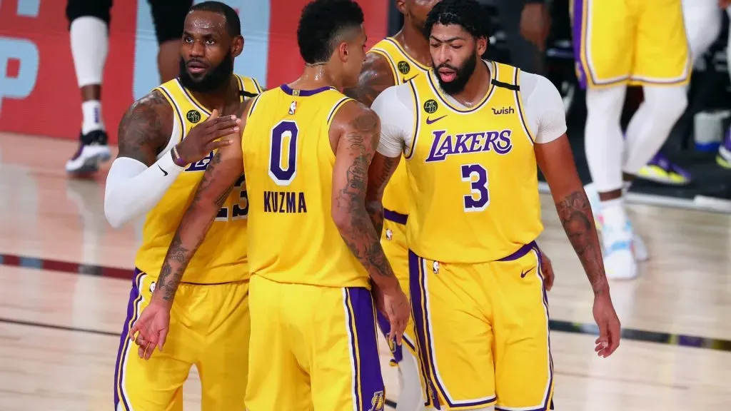 LeBron James #23, Kyle Kuzma #0 and Anthony Davis #3 of the Los Angeles Lakers huddle during the first half in game two of the first round of the NBA playoffs. Kim Klement-Pool/Getty Images