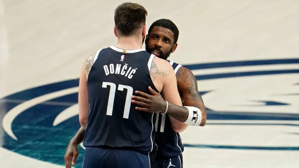 Luka Doncic #77 and Kyrie Irving #11 of the Dallas Mavericks embrace during the fourth quarter against the Minnesota Timberwolves. Cooper Neill/Getty Images