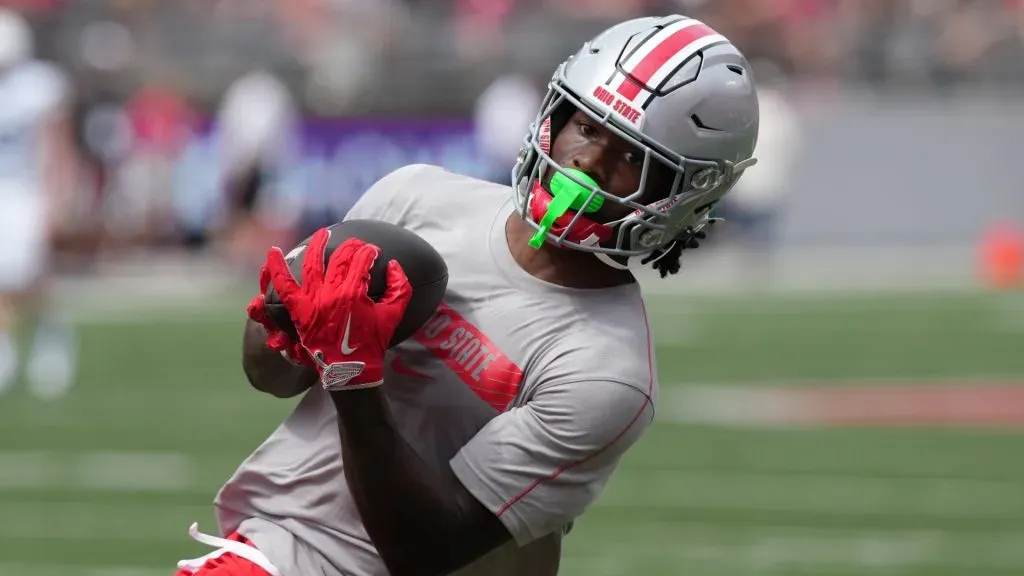 Wide receiver Jeremiah Smith #4 of the Ohio State Buckeyes catches a pass during warms up before the game against the Akron Zips at Ohio Stadium on August 31, 2024 in Columbus, Ohio.