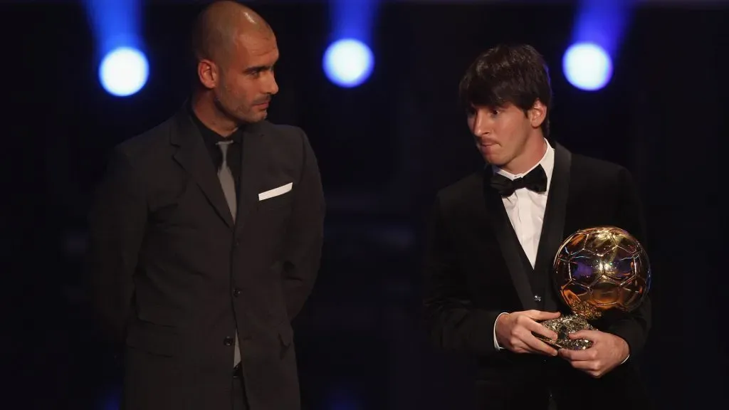 Lionel Messi (r) of Argentina and Barcelona FC receives the men’s player of the year award from his club coach Pep Guardiola. Michael Steele/Getty Images