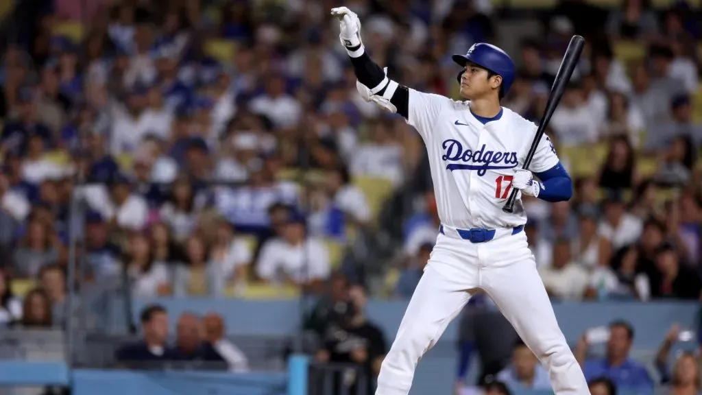 Shohei Ohtani #17 of the Los Angeles Dodgers motions to base runners Austin Barnes #15 and Enrique Hernández #8 during the third inning against the Chicago Cubs at Dodger Stadium. (Photo by Harry How/Getty Images)