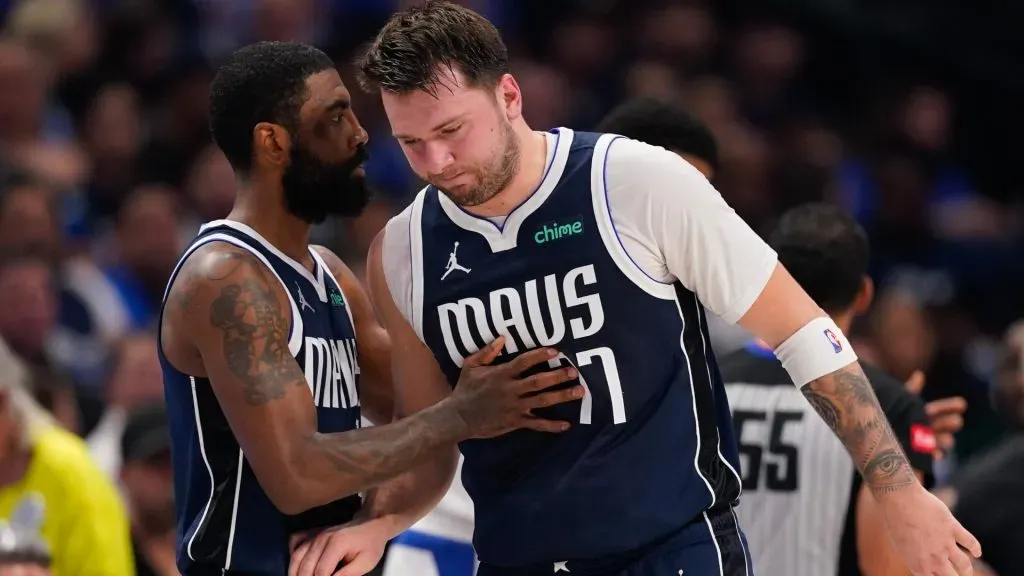 Luka Doncic #77 of the Dallas Mavericks is greeted by Kyrie Irving #11 as he walks off the court after being injured. Sam Hodde/Getty Images