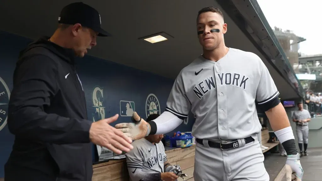 Manager Aaron Boone #17 and Aaron Judge #99 of the New York Yankees high five before the game against the Seattle Mariners at T-Mobile Park. (Photo by Steph Chambers/Getty Images)