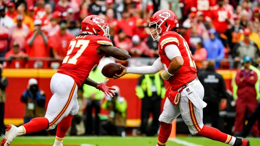 Kareem Hunt #27 of the Kansas City Chiefs takes a hand off from Patrick Mahomes #15 in their own end zone during the second quarter of the game against the Jacksonville Jaguars at Arrowhead Stadium on October 7, 2018 in Kansas City, Missouri.