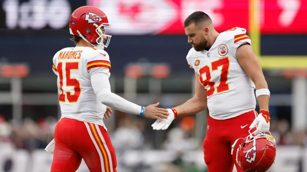 Patrick Mahomes #15 and Travis Kelce #87 of the Kansas City Chiefs high five during the first half against the New England Patriots at Gillette Stadium on December 17, 2023 in Foxborough, Massachusetts.