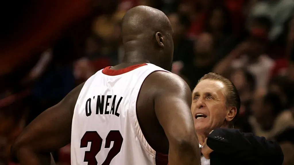 Head Coach Pat Riley of the Miami Heat chats with Shaquille O’Neal #32 during a break. Eliot J. Schechter/Getty Images