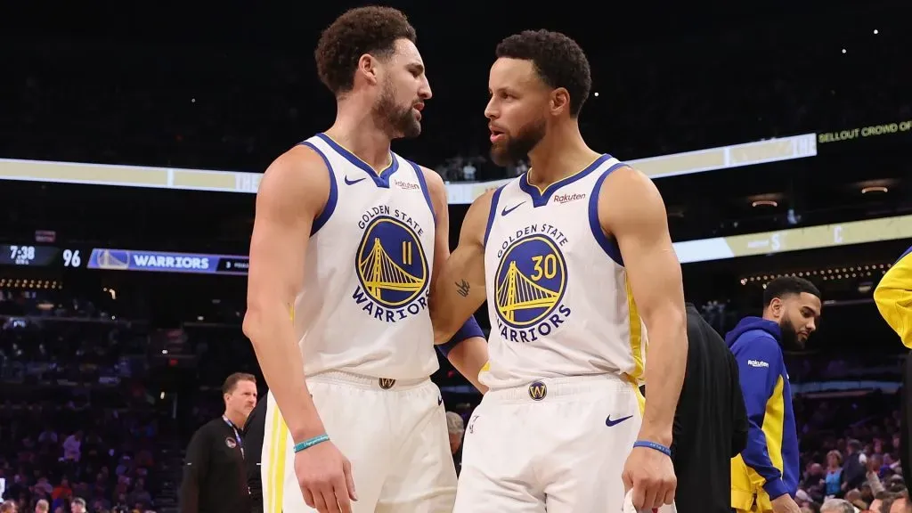 Stephen Curry #30 of the Golden State Warriors talks with Klay Thompson #11during the NBA game at Footprint Center on December 12, 2023 in Phoenix, Arizona. The Suns defeated the Warriors 119-116.