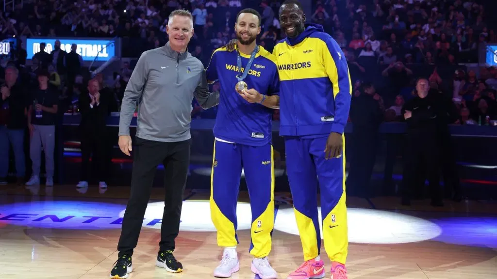 Golden State Warriors head coach Steve Kerr, from left, Stephen Curry #30 and Draymond Green #23 pose for photos during an Olympic Gold Medal recognition ceremony before their preseason game against the Sacramento Kings at Chase Center on October 11, 2024 in San Francisco, California. (Photo by Ezra Shaw/Getty Images)