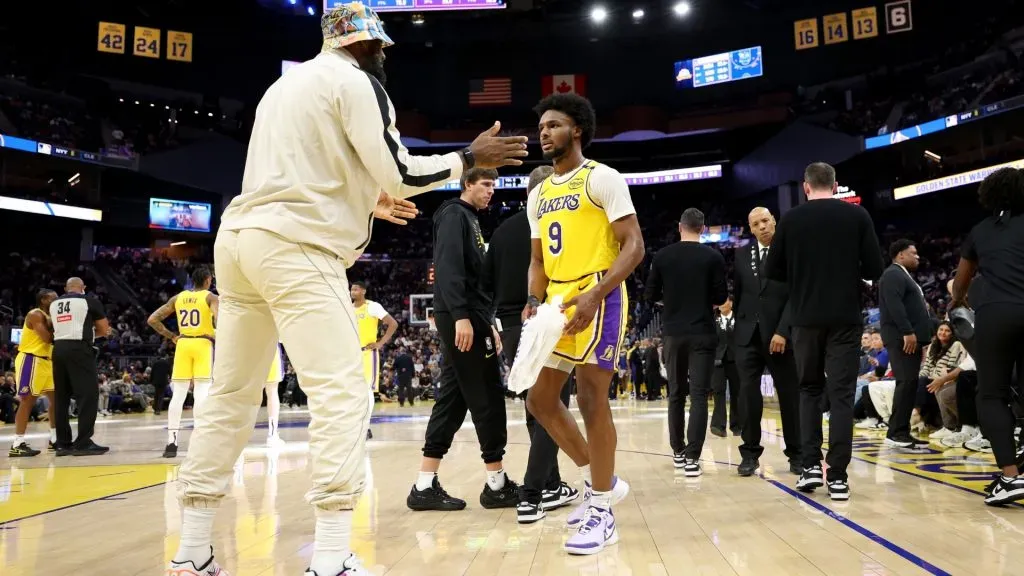 LeBron James #23 of the Los Angeles Lakers talks to his son, Bronny James #9, during a timeout of their preseason game against the Golden State Warriors at Chase Center on October 18, 2024 in San Francisco, California. (Photo by Ezra Shaw/Getty Images)