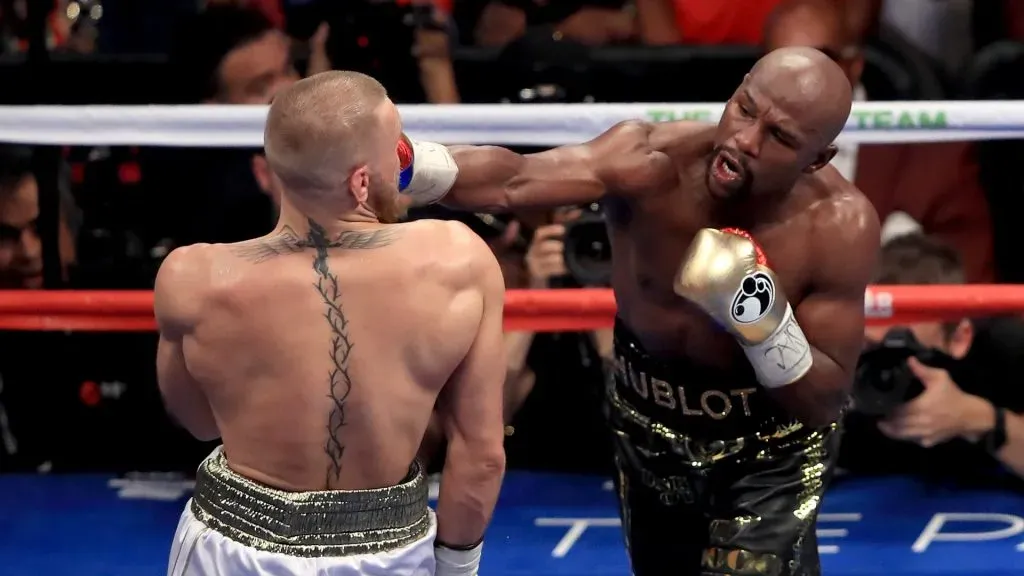 (R-L) Floyd Mayweather Jr. throws a punch at Conor McGregor during their super welterweight boxing match on August 26, 2017 at T-Mobile Arena in Las Vegas, Nevada.