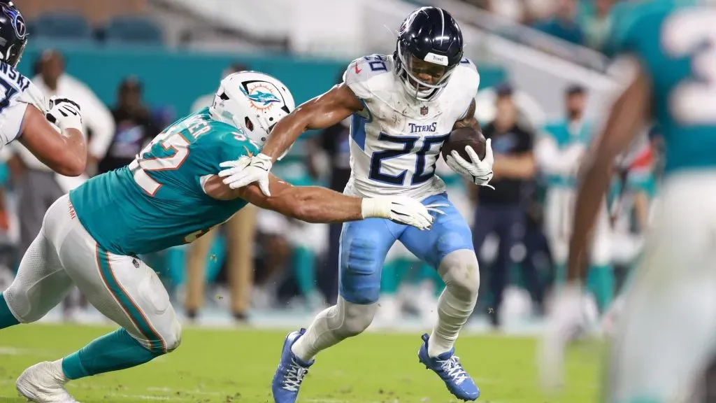 Zach Sieler of the Miami Dolphins tackles Tennessee Titans’ Tony Pollard during the first quarter at Hard Rock Stadium on September 30, 2024 in Miami Gardens, Florida.