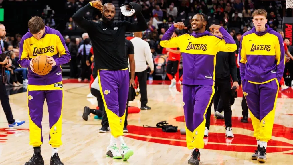 LeBron James #23 and Bronny James #9 of the Los Angeles Lakers flex as they warm up alongside Austin Reaves #15 and Dalton Knecht #4 ahead of their NBA game against the Toronto Raptors at Scotiabank Arena on November 1, 2024 in Toronto, Canada. (Photo by Cole Burston/Getty Images)