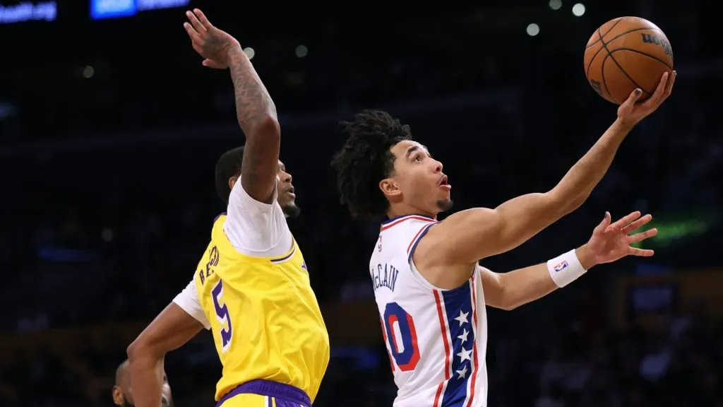 Jared McCain #20 of the Philadelphia 76ers scores on a layup past Cam Reddish #5 of the Los Angeles Lakers during the first half at Crypto.com Arena. Harry How/Getty Images