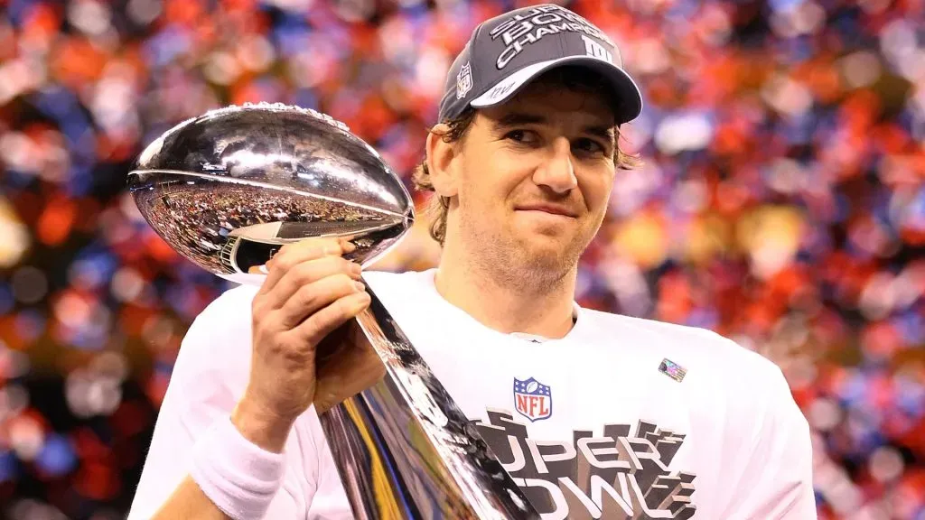 Eli Manning #10 of the New York Giants hoist the Vince Lombardi Trophy after defeating the New England Patriots in Super Bowl XLVI at Lucas Oil Stadium on February 5, 2012. (Source: Al Bello/Getty Images)