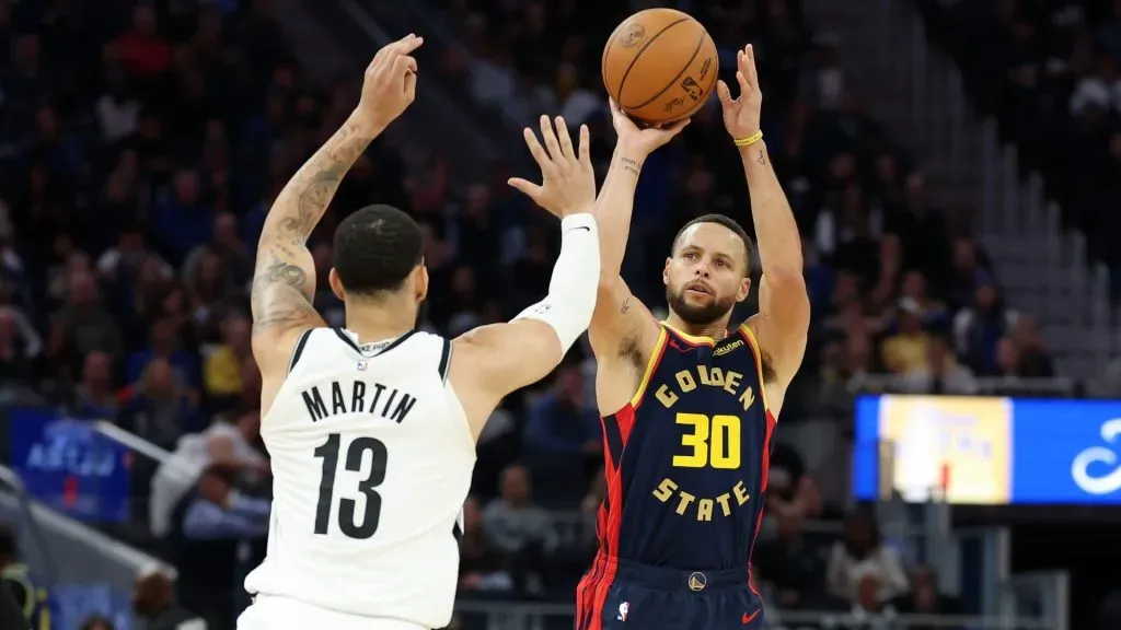 Stephen Curry #30 of the Golden State Warriors shoots over Tyrese Martin #13 of the Brooklyn Nets in the second half at Chase Center. (Ezra Shaw/Getty Images)