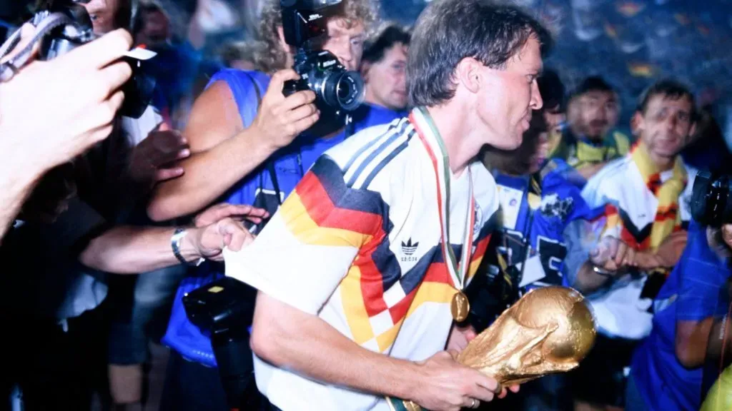 Lothar Matthaus at the victory celebration on the pitch with the World Cup trophy, after FIFA World Cup 1990 Final in Italy.