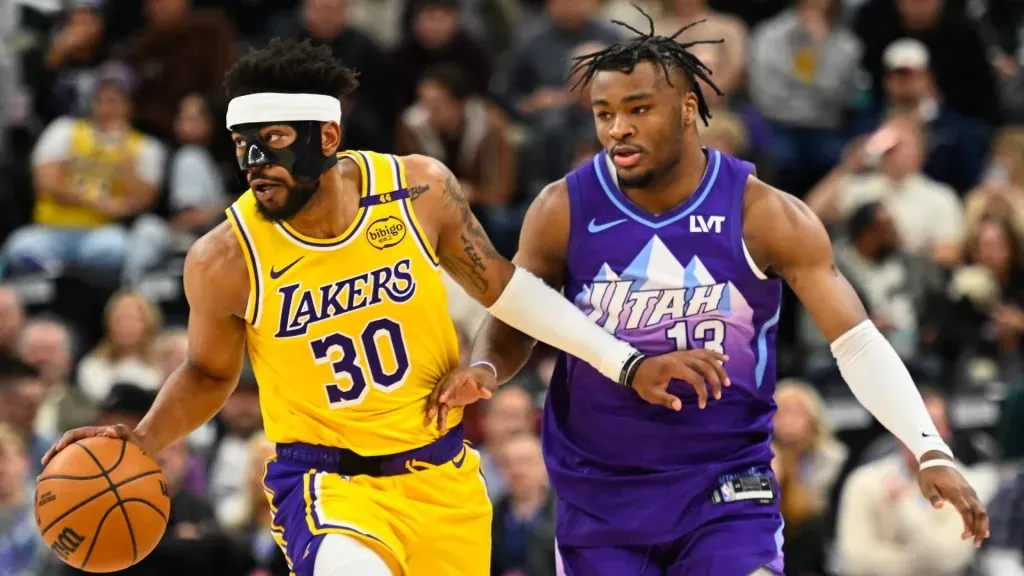 Jordan Goodwin #30 of the Los Angeles Lakers drives past Isaiah Collier #13 of the Utah Jazz during the second half of a game at Delta Center. (Alex Goodlett/Getty Images)