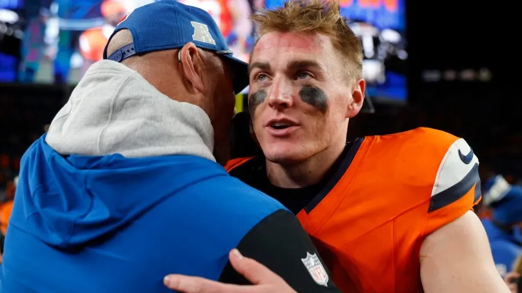 Bo Nix #10 of the Denver Broncos embraces an Indianapolis Colts staff member after the game at Empower Field At Mile High on December 15, 2024. (Source: Justin Edmonds/Getty Images)