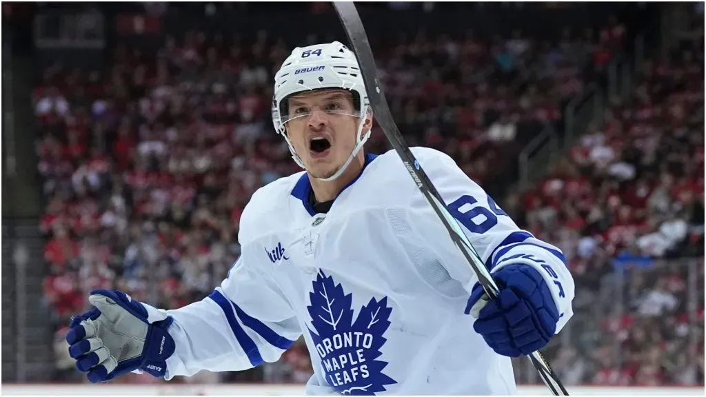 David Kampf #64 of the Toronto Maple Leafs reacts after a goal by Steven Lorentz #18 against the New Jersey Devils in the first period at the Prudential Center on October 10, 2024 in Newark, New Jersey.