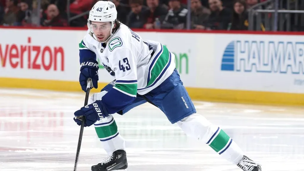 Quinn Hughes #43 of the Vancouver Canucks takes the puck in the third period against the New Jersey Devils at Prudential Center on March 24, 2025 in Newark, New Jersey. (Photo by Elsa/Getty Images)