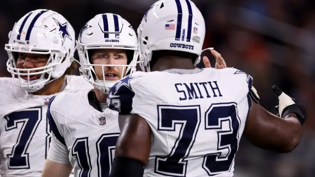 The Dallas Cowboys celebrates with Tyler Smith #73 after a touchdown