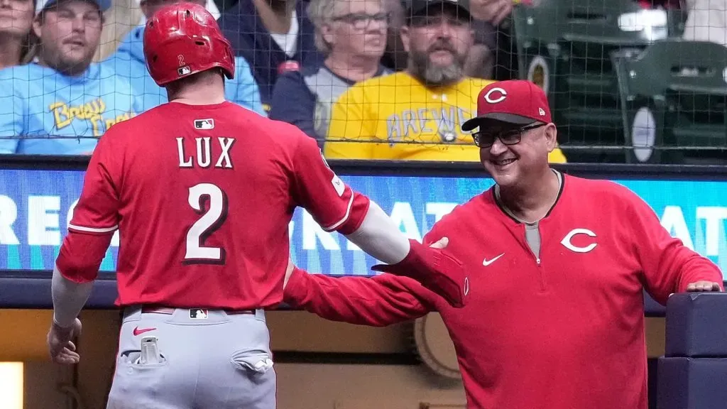 Gavin Lux #2 of the Reds is congratulated by Terry Francona #77 after scoring in the sixth inning against the Milwaukee Brewers. (Photo by John Fisher/Getty Images)