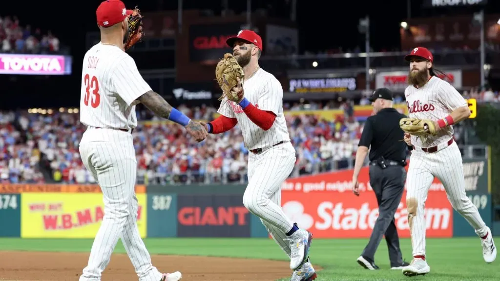 Bryce Harper #3 of the Phillies is congratulated by Edmundo Sosa #33 after a catch to end the fifth inning against the Dodgers in game two of the NLDS. (Photo by Emilee Chinn/Getty Images)
