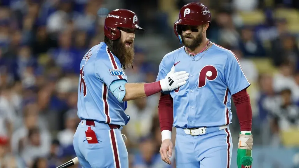 Bryce Harper #3 and Brandon Marsh #16 of the Phillies celebrate after scoring a run against the Dodgers. (Photo by Ronald Martinez/Getty Images)