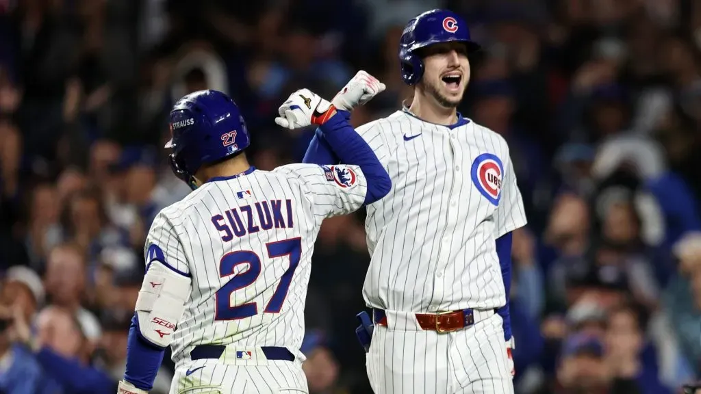 Seiya Suzuki #27 and Kyle Tucker #30 of the Cubs celebrate after Tucker hit a home run against the Brewers. Geoff Stellfox/Getty Images