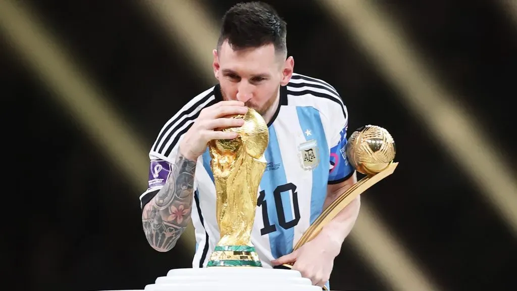 Lionel Messi of Argentina kisses the FIFA World Cup Qatar 2022 Winners’ Trophy. Julian Finney/Getty Images
