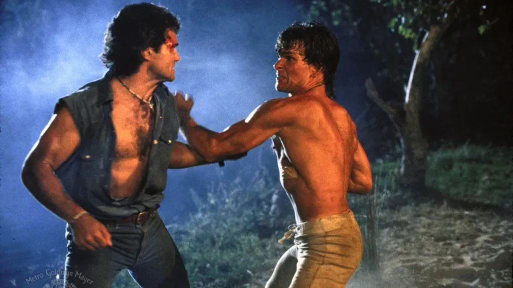 Patrick Swayze and Marshall R. Teague in Road House. (Source: IMDb)