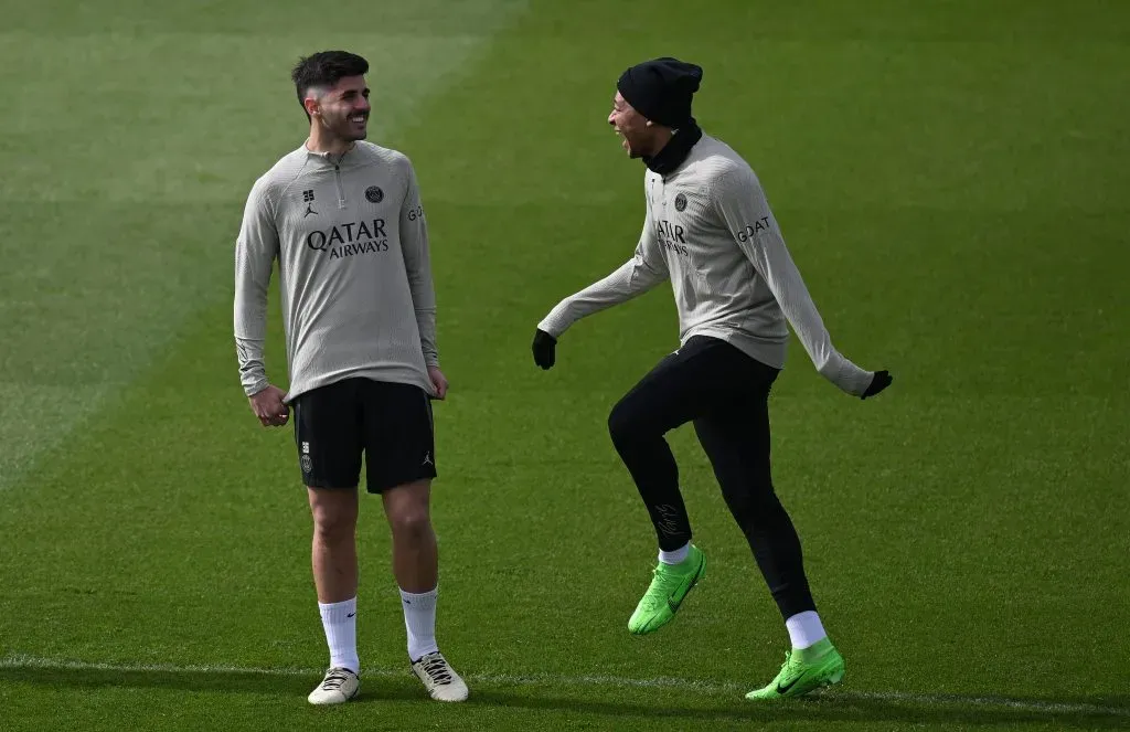 Kylian Mbappé  laughs with Lucas Beraldo of PSG(Photo by Stuart Franklin/Getty Images)