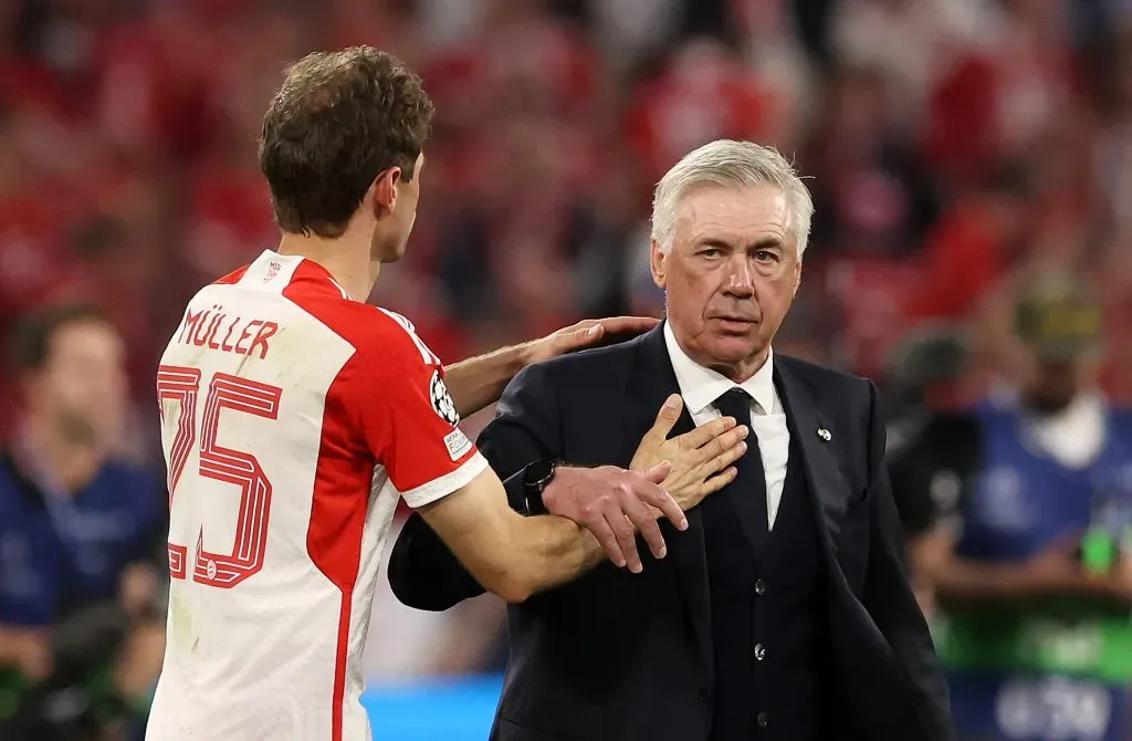 Thomas Mueller of Bayern Munich and Carlo Ancelotti, of Real Madrid,(Photo by Alexander Hassenstein/Getty Images)