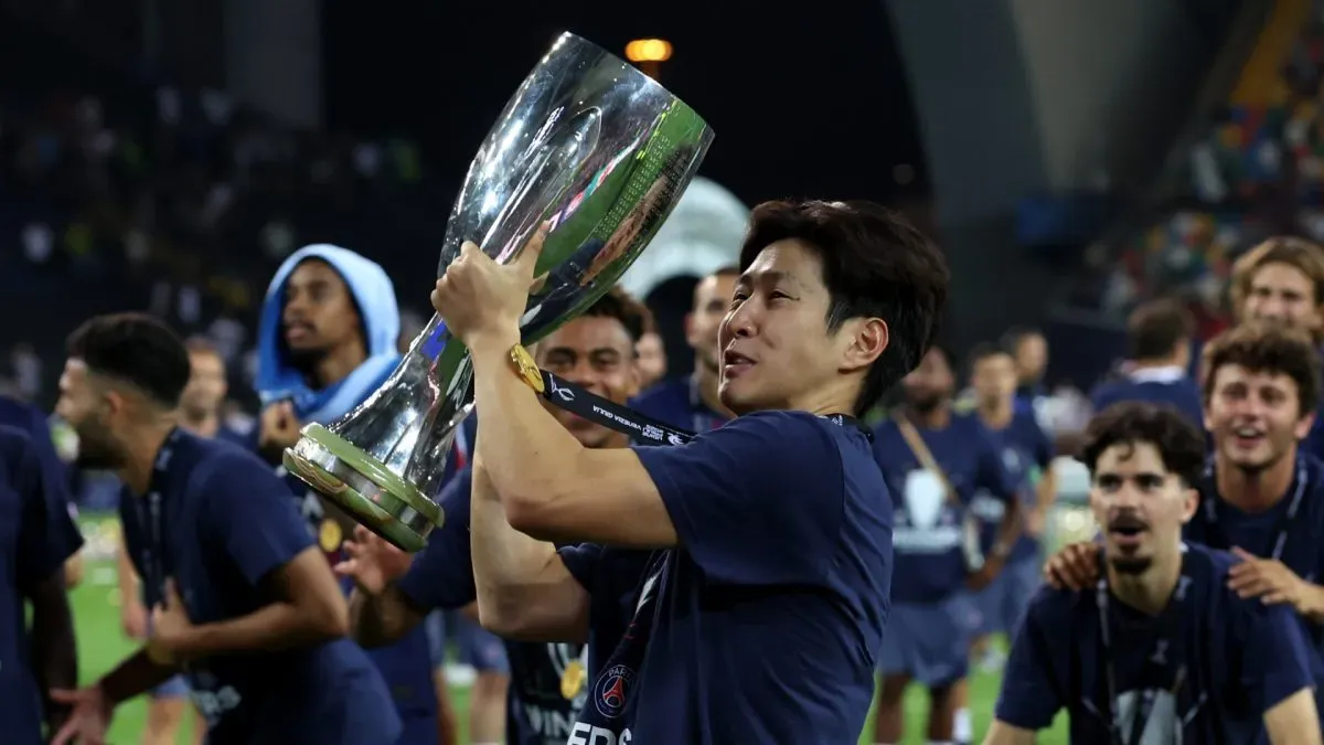 Lee Kang-In of Paris Saint-Germain celebrates with the UEFA Super Cup trophy.