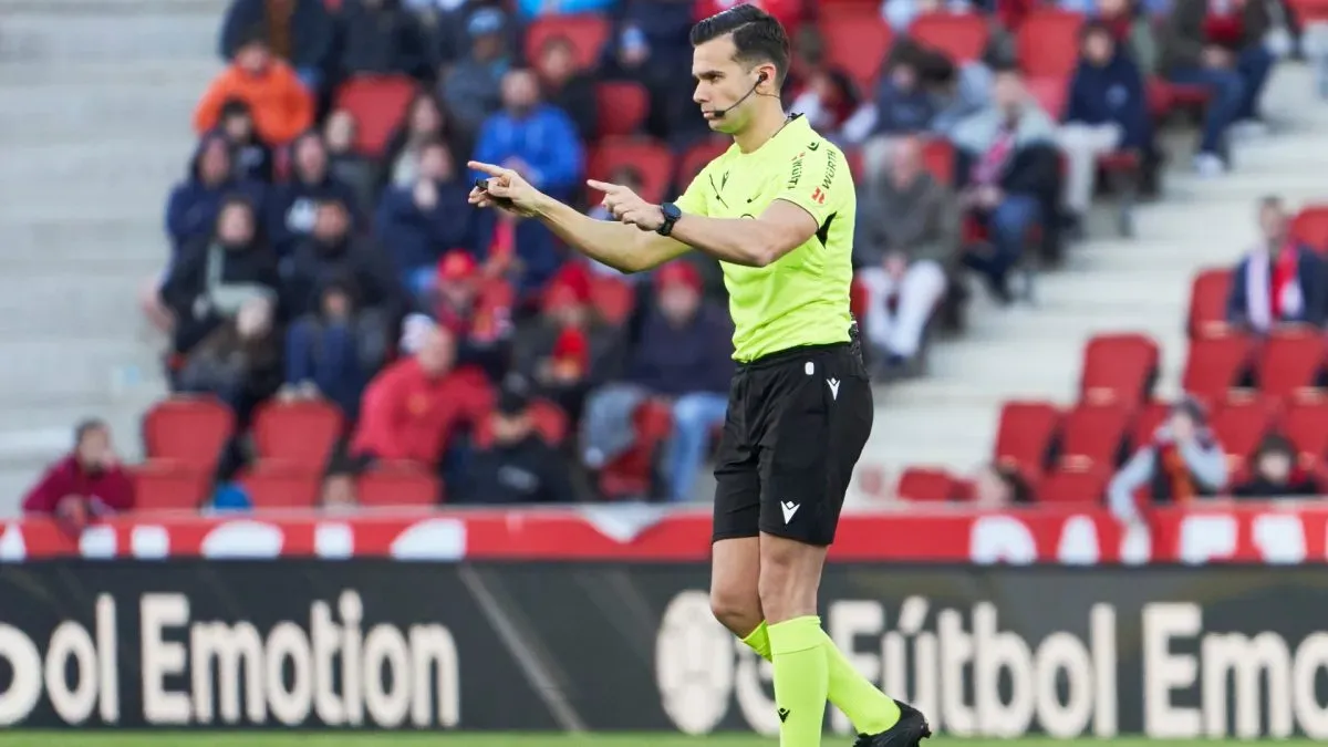 Referee Alejandro Quintero González gestures for a VAR review during the LaLiga match between RCD Mallorca and RCD Espanyol.