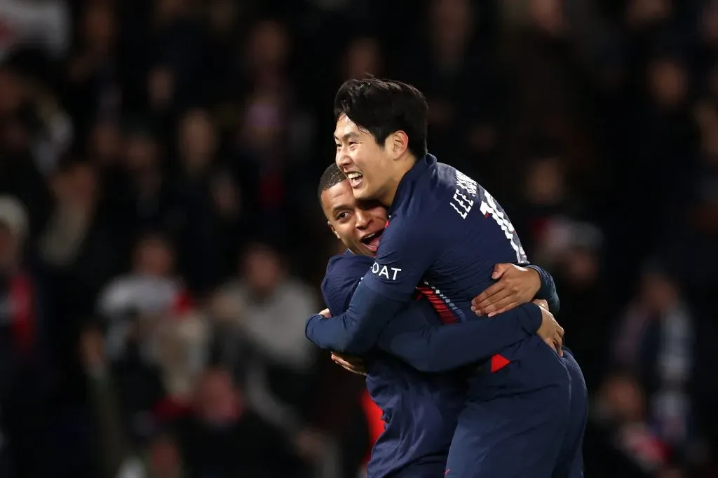 Lee Kang-In of PSG celebrates with team mate Kylian Mbappe (Photo by Alex Pantling/Getty Images)