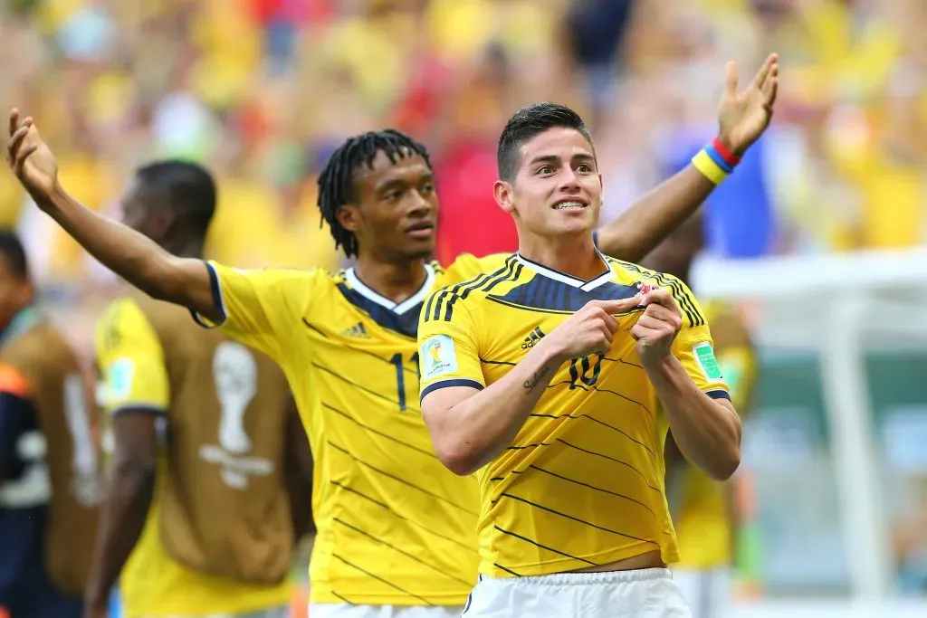 Juan Guillermo Cuadrado celebra con James un gol en Brasil 2014. Getty.