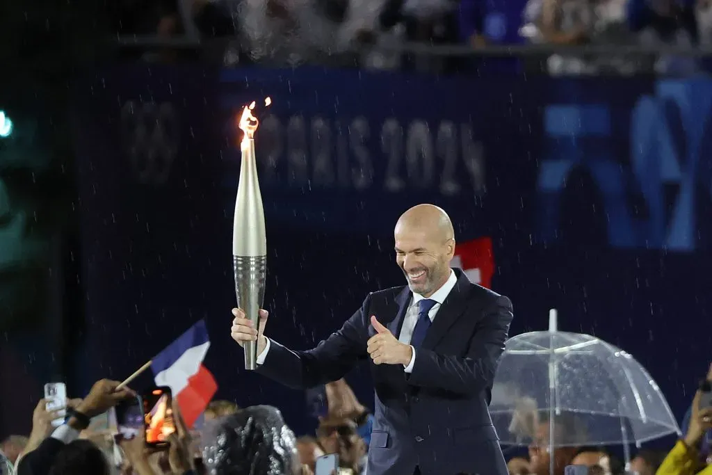 La Antorcha Olímpica en manos del ex futbolista Zinedine Zidane, durante la ceremonia de inauguración de París 2024. (Imago)