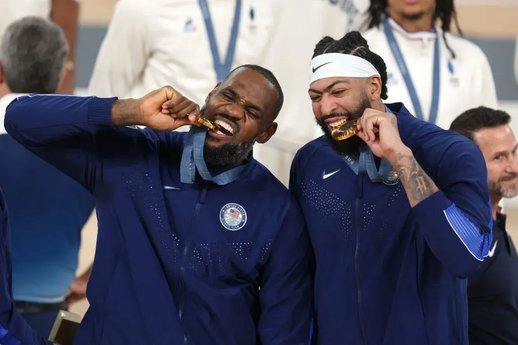 Gold medalists LeBron James and Anthony Davis of Team United States bite their medals. Jamie Squire/Getty Images