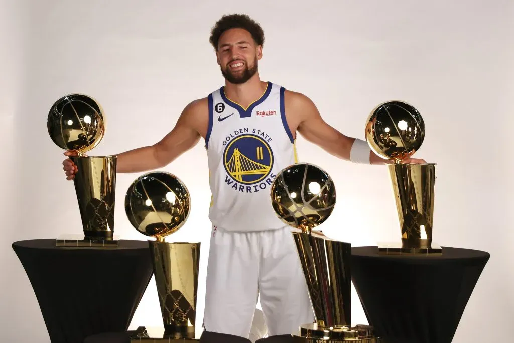 Klay Thompson of the Golden State Warriors poses with the four Larry O’Brien Championship Trophies that he has won with the  Warriors. Ezra Shaw/Getty Images