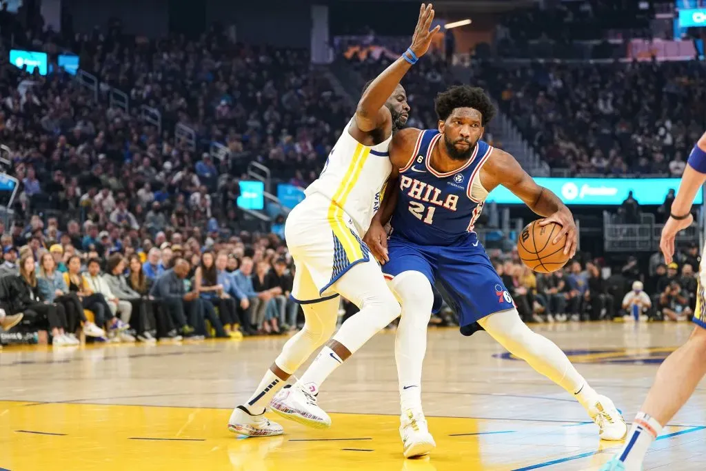 Joel Embiid #21 of the Philadelphia 76ers dribbles the ball in the first quarter against Draymond Green #23 of the Golden State Warriors. Kavin Mistry/Getty Images