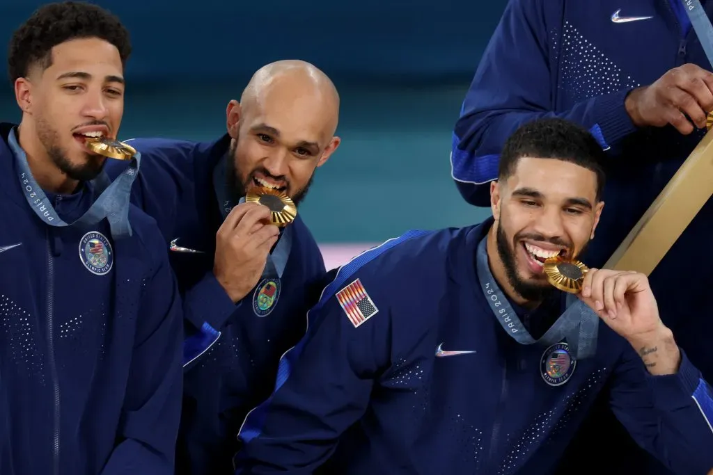 Gold medalists Tyrese Haliburton, Derrick White, and Jayson Tatum of Team United States pose with their medals. Jamie Squire/Getty Images