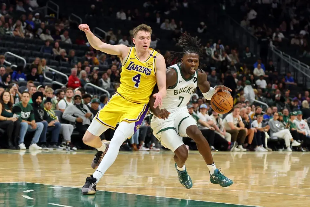 Chris Livingston #7 of the Milwaukee Bucks is defended by Dalton Knecht #4 of the Los Angeles Lakers during a preseason game. Stacy Revere/Getty Images