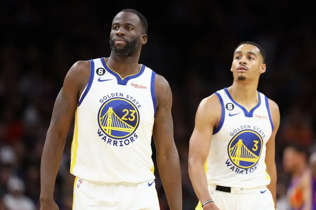 Draymond Green #23 and Jordan Poole #3 of the Golden State Warriors walk to the bench during the second half of the NBA game against the Phoenix Suns. Christian Petersen/Getty Images