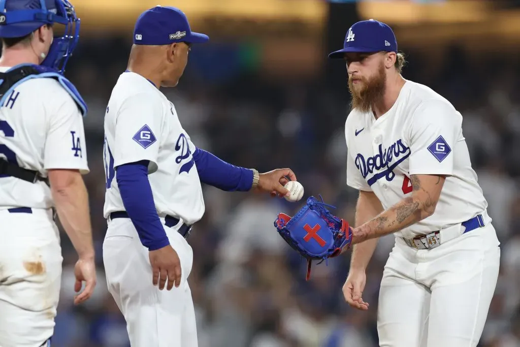 LOS ANGELES, CALIFORNIA – OCTOBER 11: Michael Kopech #45 of the Los Angeles Dodgers receives the ball from manager Dave Roberts #30 as he enters the game against the San Diego Padres during the eighth inning of Game Five of the Division Series at Dodger Stadium on October 11, 2024 in Los Angeles, California.  (Photo by Sean M. Haffey/Getty Images)