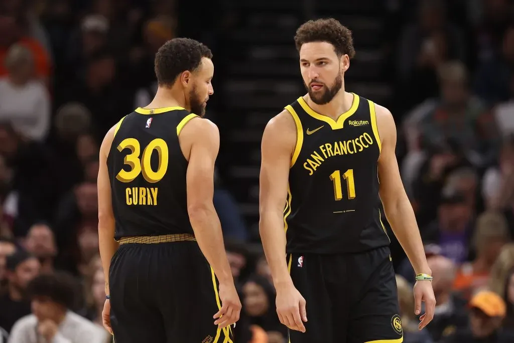 Klay Thompson #11 of the Golden State Warriors talks with Stephen Curry #30 during the second half of the NBA game against the Phoenix Suns. Christian Petersen/Getty Images