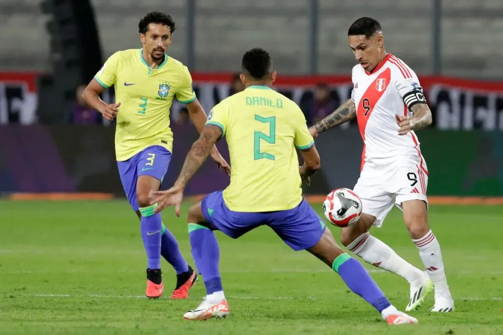 LIMA, PERU – SEPTEMBER 12: Paolo Guerrero of Peru competes for the ball with Danilo of Brazil during a FIFA World Cup 2026 Qualifier match between Peru and Brazil at Estadio Nacional de Lima on September 12, 2023 in Lima, Peru. (Photo by Mariana Bazo/Getty Images)